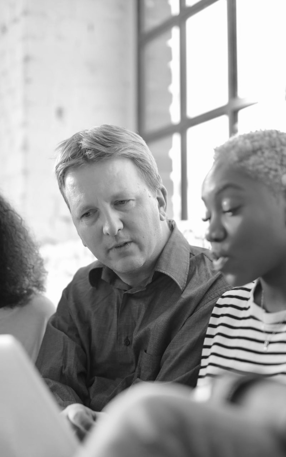 Professionals collaborating in a bright executive workspace