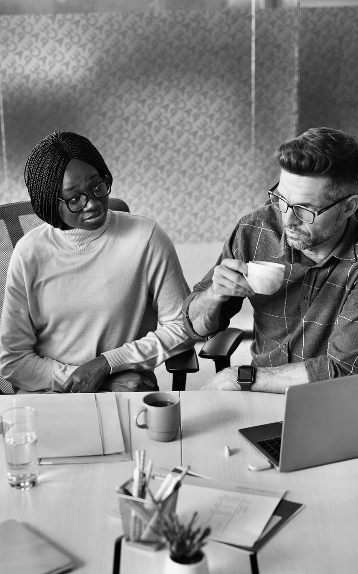Colleagues meeting around a table in a private office